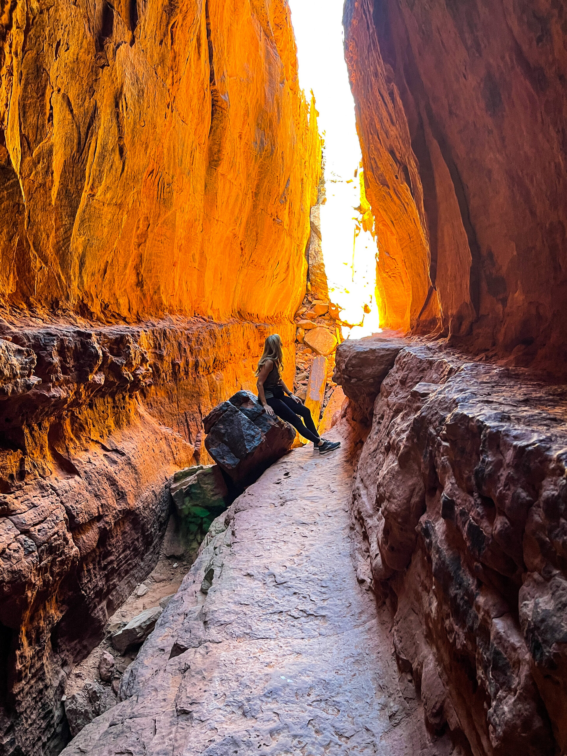 iPhone travel photo of sun glowing on red rocks in Soldier Cave in Sedona Arizona