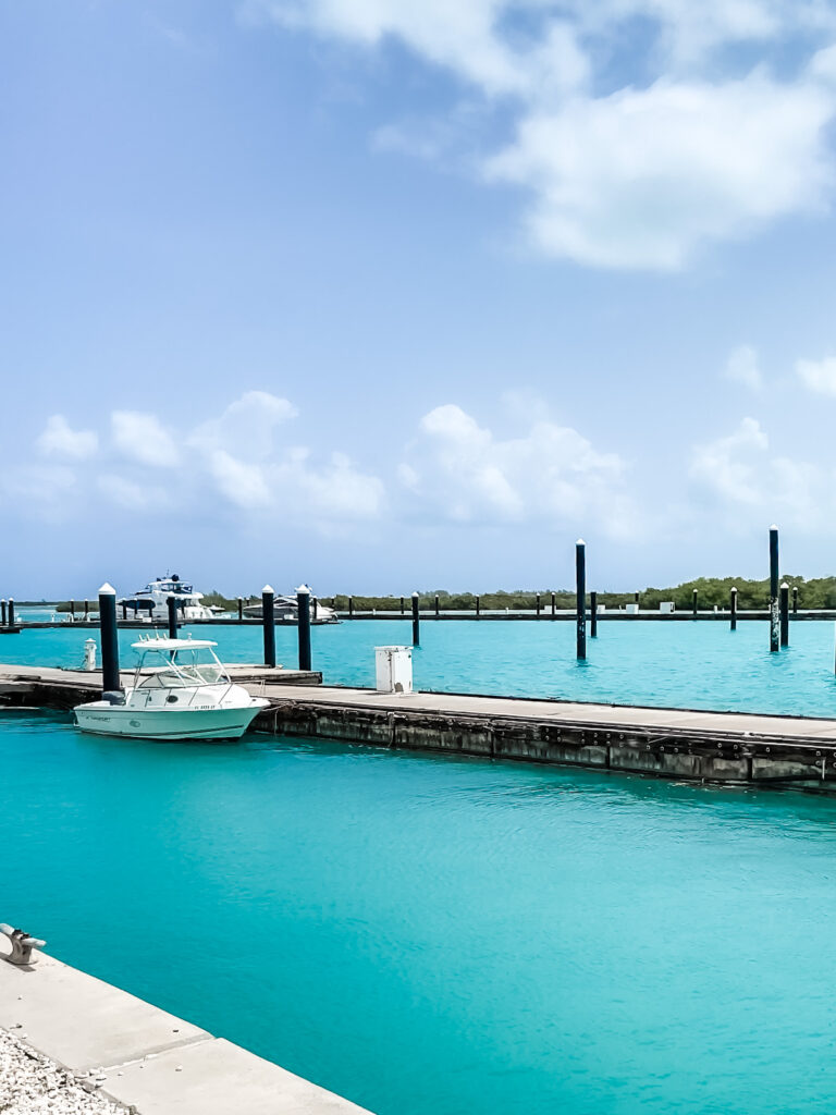 iPhone travel photo of boat in turquoise ocean tied to dock in Turks and Caicos